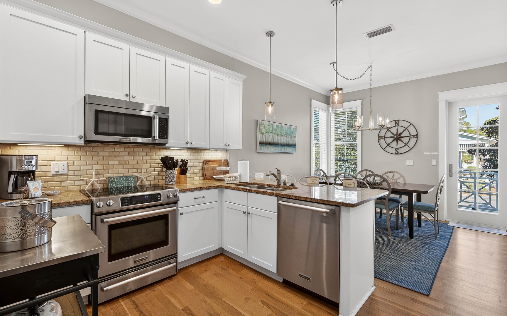 Your fully equipped kitchen flows seamlessly into the dining area, where natural light and modern fixtures create the perfect space for home-cooked meals.