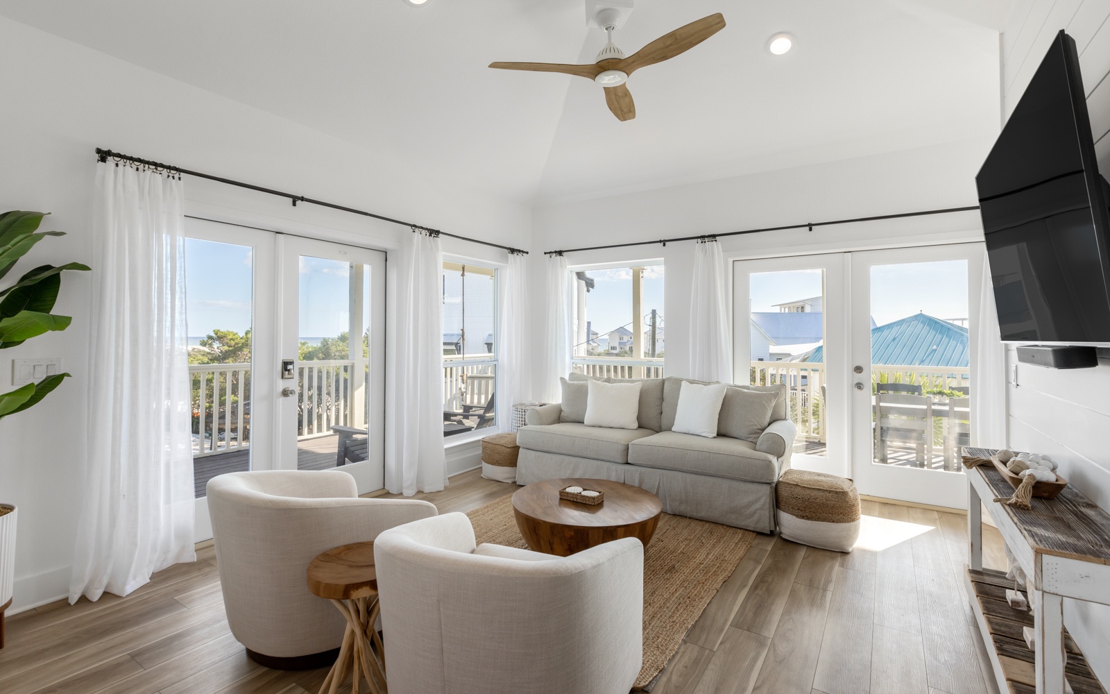 Relax in your bright, airy living room where natural light floods through floor-to-ceiling windows and coastal breezes flow from your private balcony.