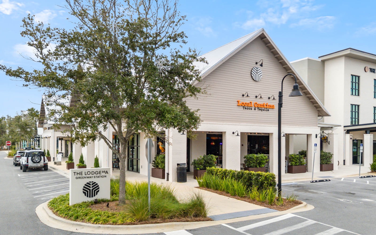 Modern property exterior featuring local dining options and convenient parking in a well-designed commercial area.