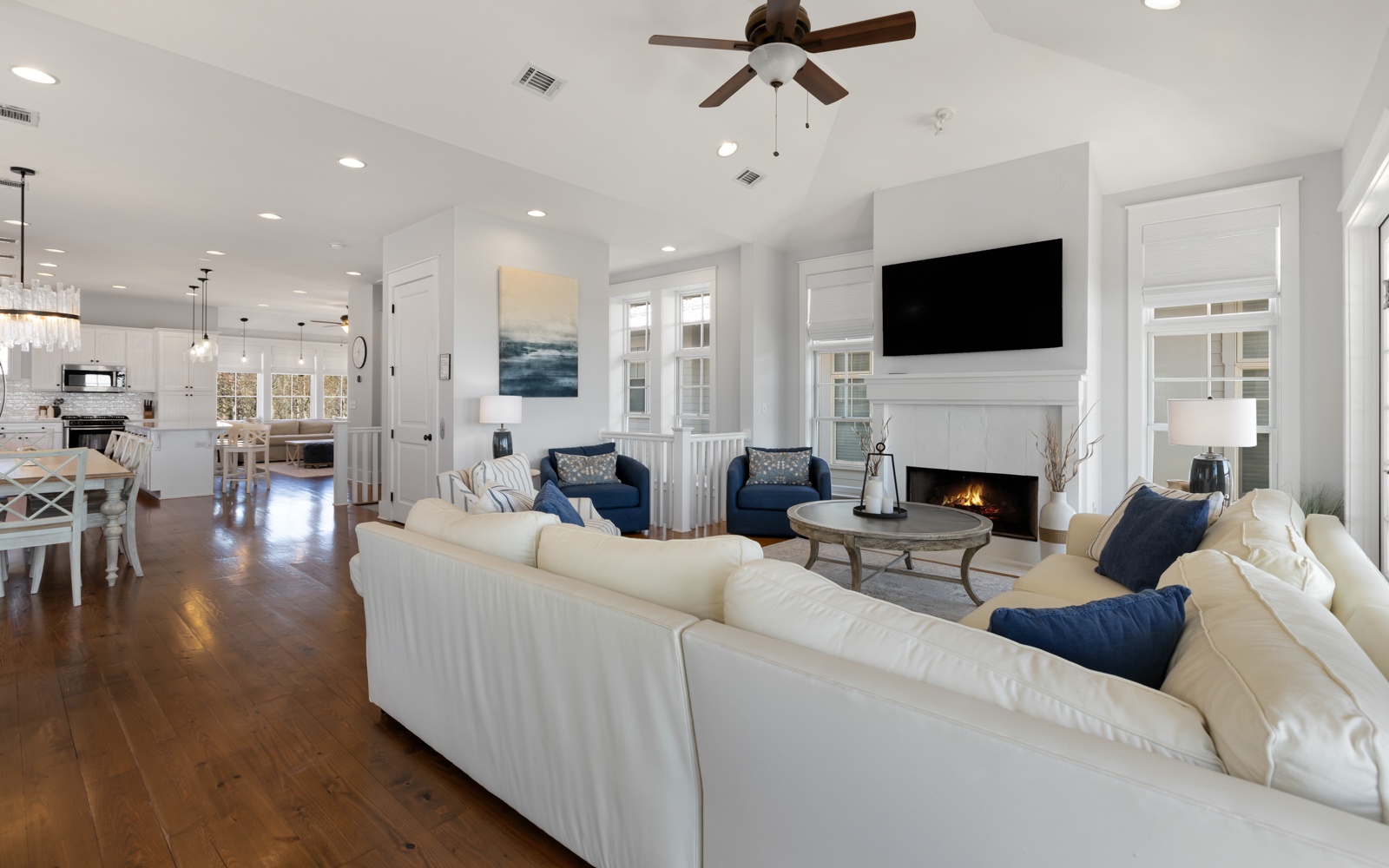 Relax in this bright, open living space featuring plush seating, a cozy fireplace, and seamless flow to your fully equipped kitchen.