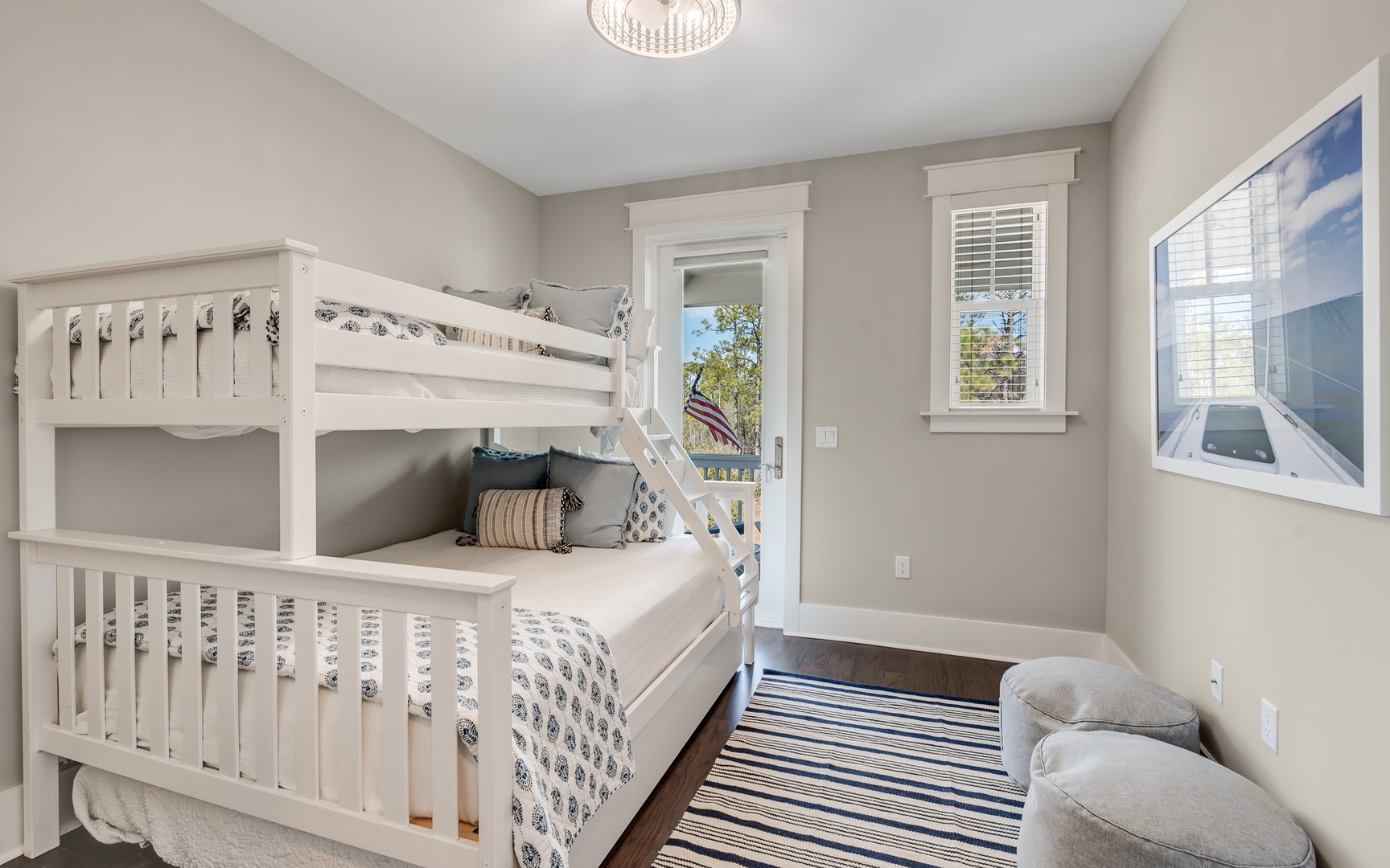 Your kids will love this cozy bunk room with its cheerful white beds, soft linens, and bright windows overlooking the neighborhood.