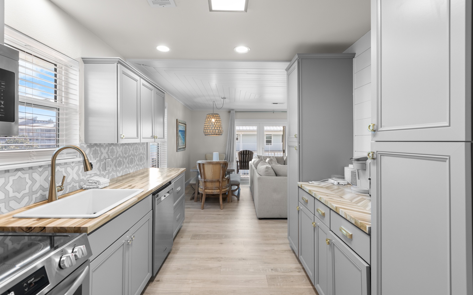Your fully equipped galley kitchen flows seamlessly into the living space, featuring brass fixtures and elegant details.