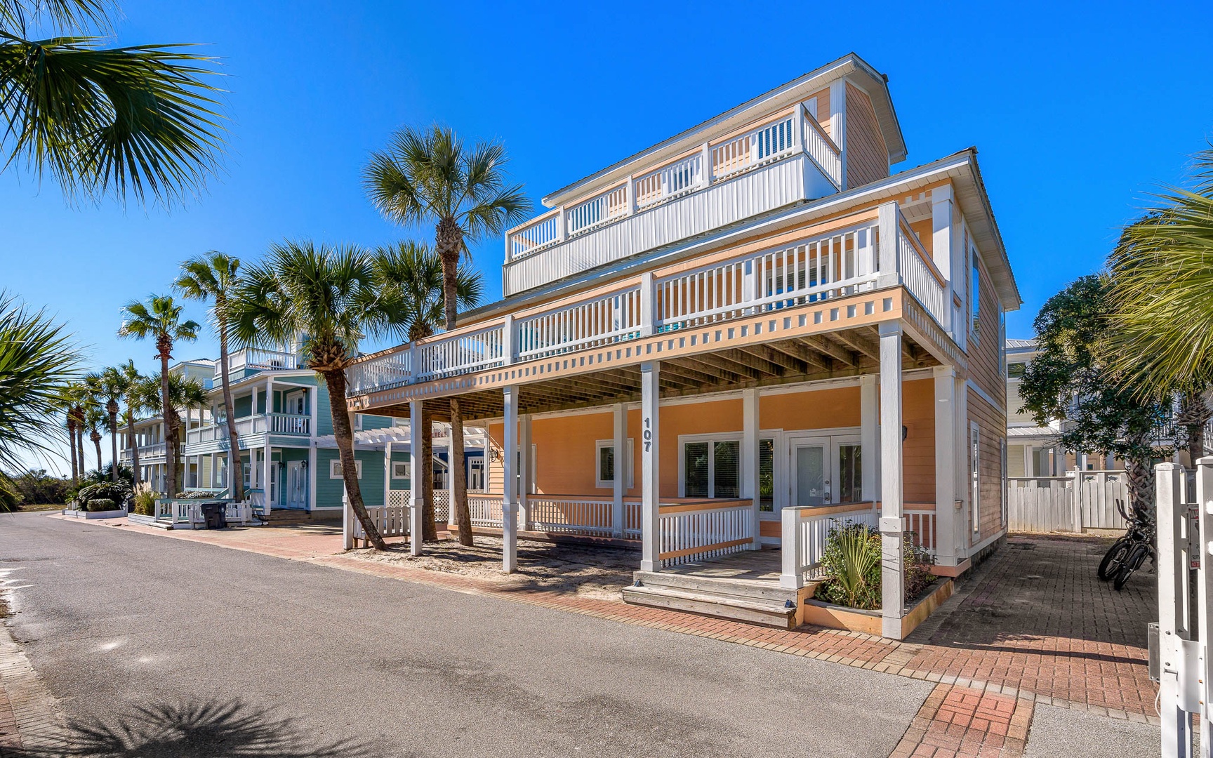 Charming coastal property with tropical palm trees and classic beach architecture in a peaceful residential setting.