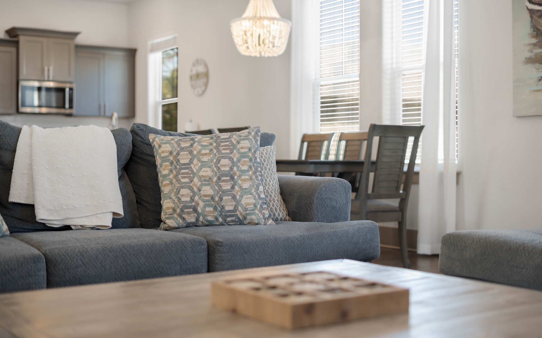 Sink into the plush sectional sofa where soft throw pillows invite you to unwind in this bright, open living space.