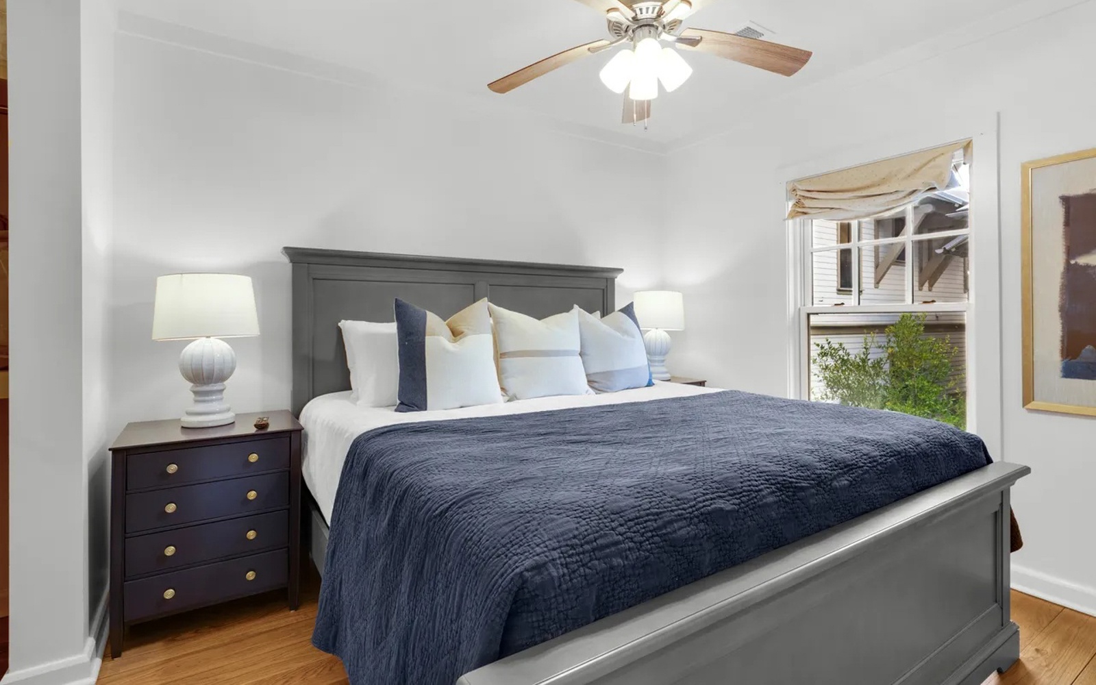 Your peaceful bedroom awaits with crisp linens, soft lighting, and a gentle ceiling fan for ultimate comfort.