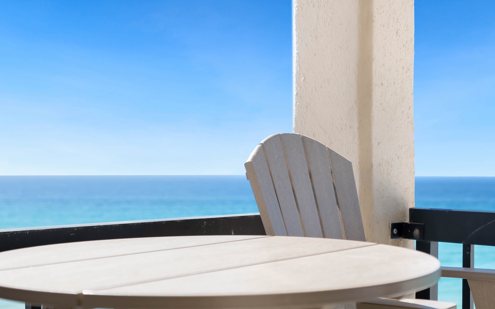 Relax at your private table with stunning ocean views stretching to the horizon from this peaceful balcony retreat.