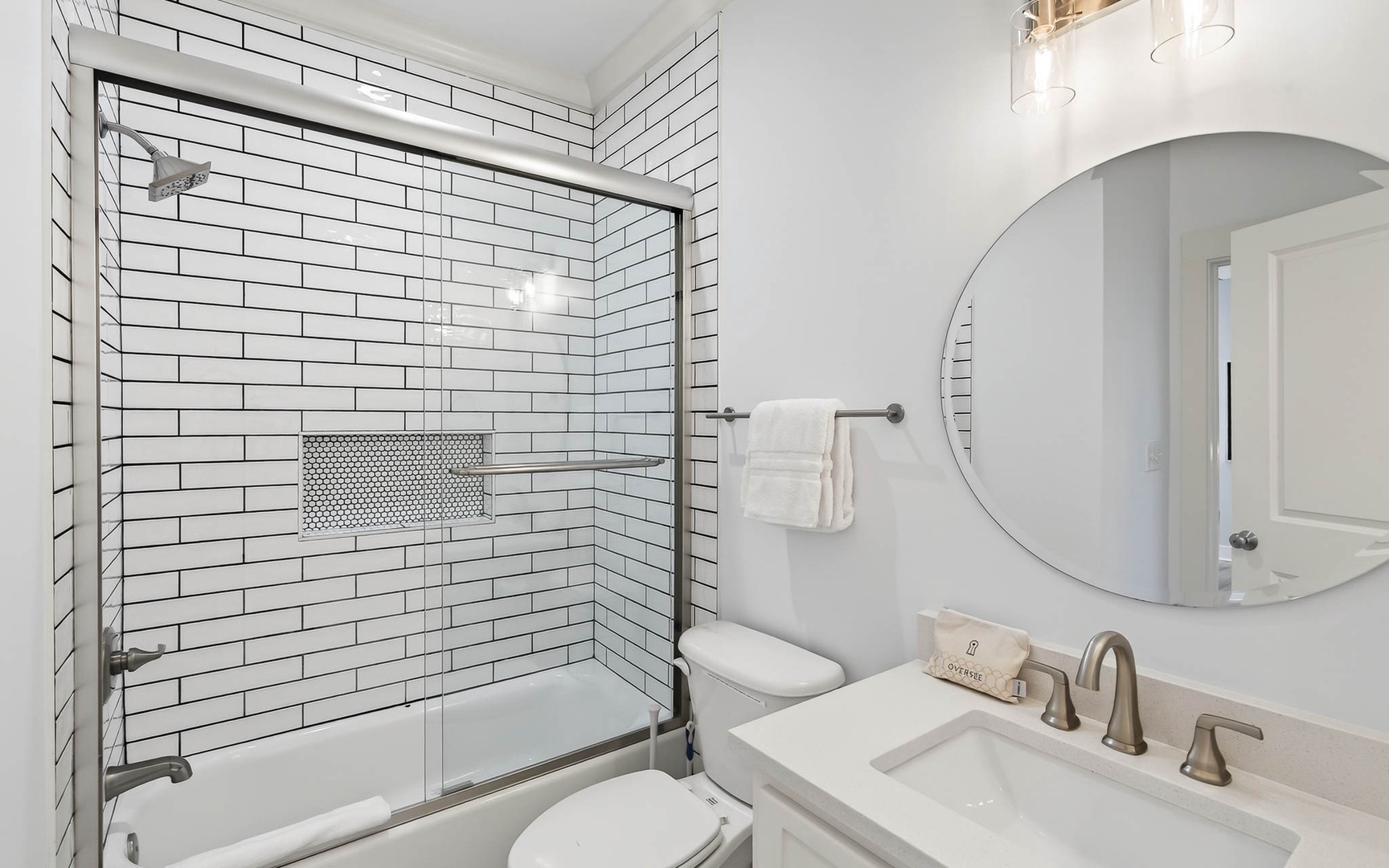 Refresh yourself in this bright, modern bathroom featuring elegant subway tile, spacious tub-shower combo, and premium fixtures for your comfort.