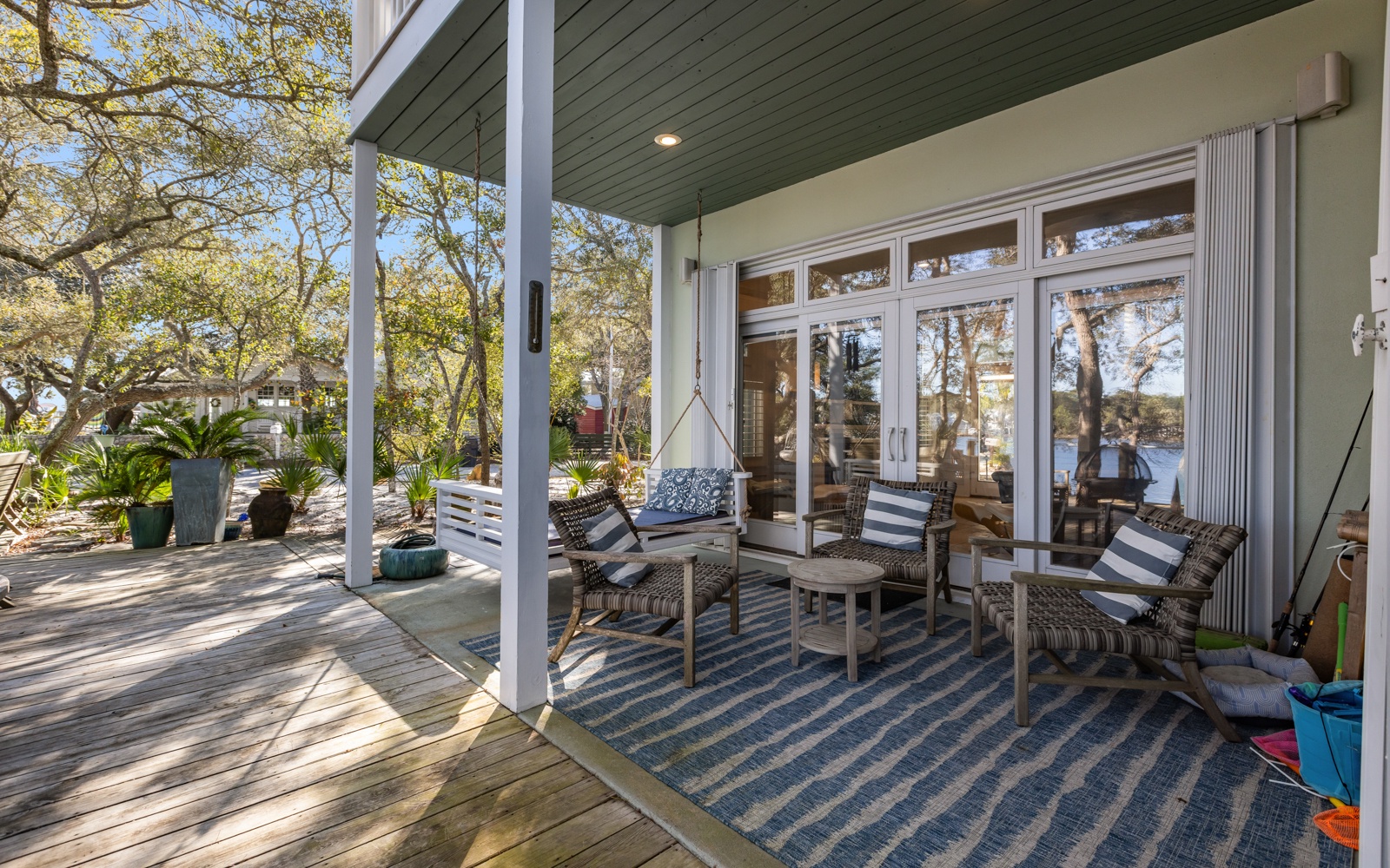 Relax in your private covered deck with wicker seating and waterfront views through mature trees.