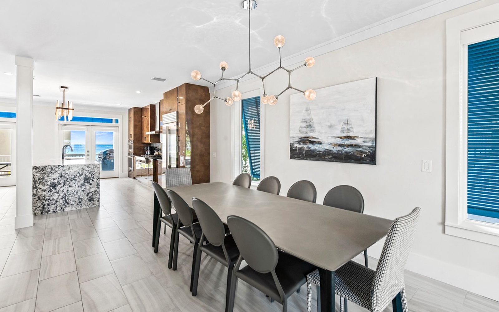 Your elegant dining space features a striking modern chandelier and sleek table for memorable meals with loved ones.
