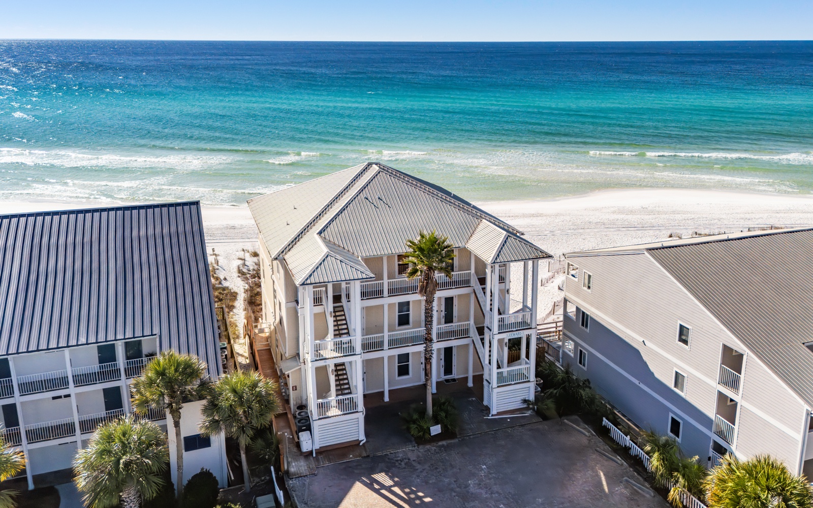 Beachfront vacation rental with direct beach access and stunning turquoise waters just steps from the property.