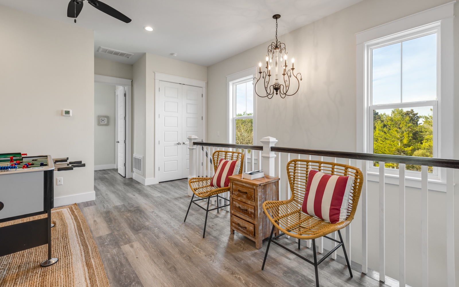 Your upstairs landing offers a charming seating nook with tree views, perfect for morning coffee or quiet moments between beach adventures.
