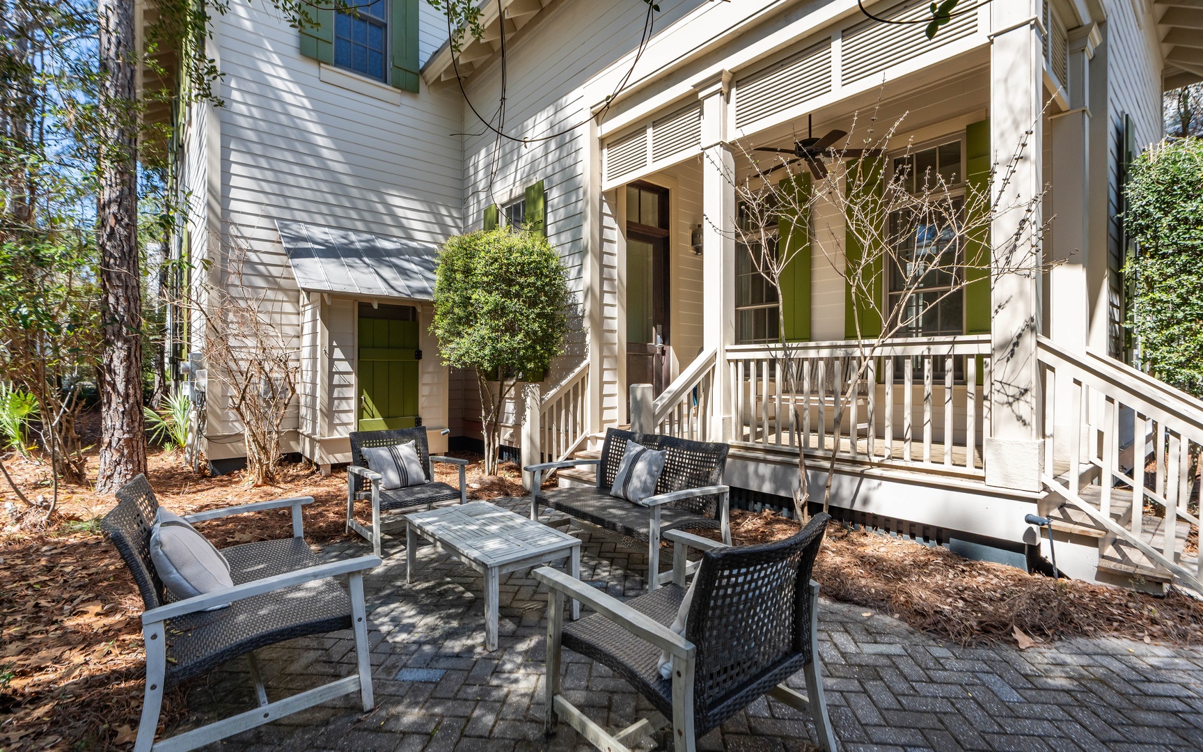 Step onto your private patio where comfortable seating awaits beneath dappled sunlight, perfect for morning coffee or evening conversations.