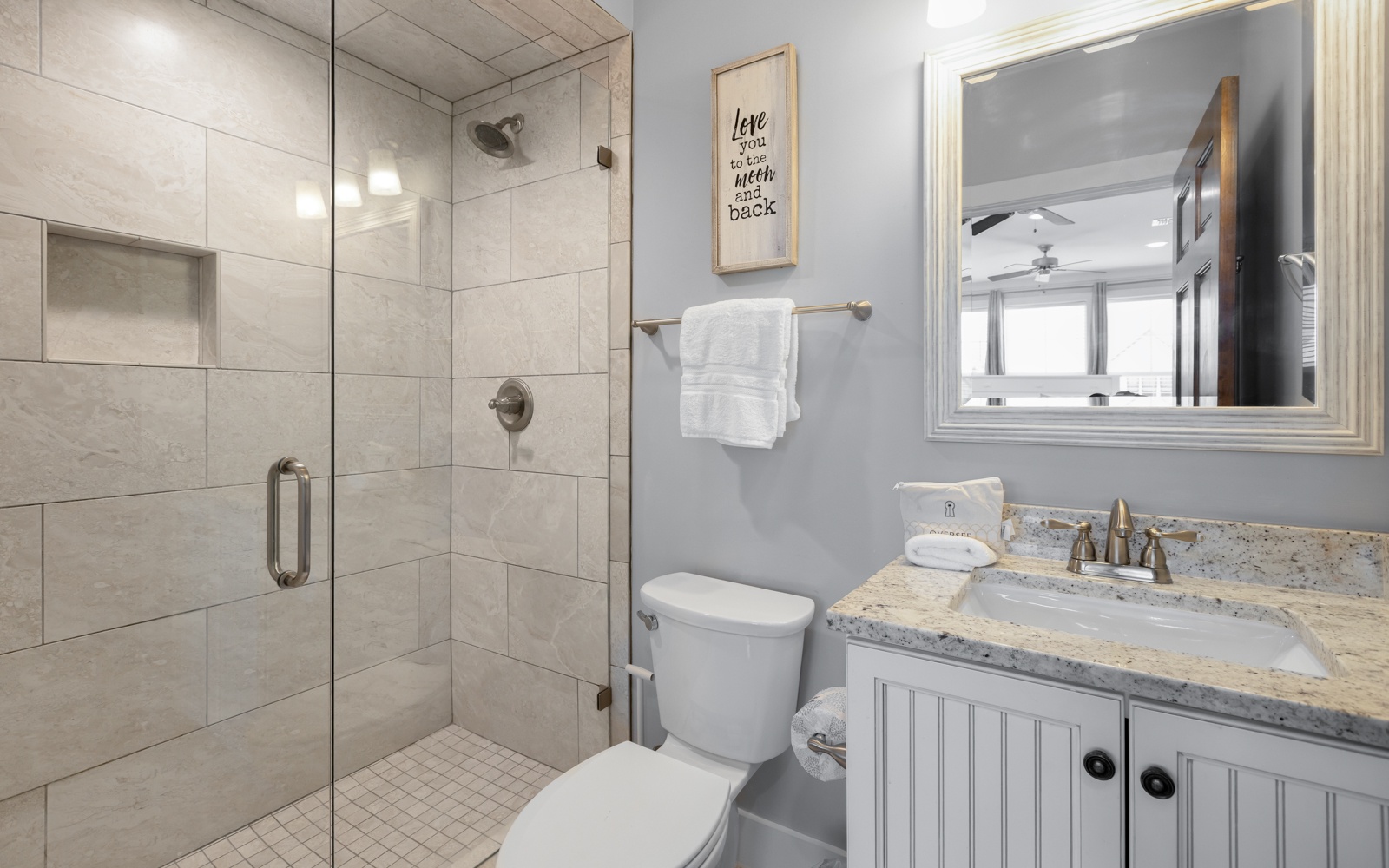 Your modern bathroom features a spacious walk-in shower and granite vanity, where fresh towels and thoughtful touches await your arrival.