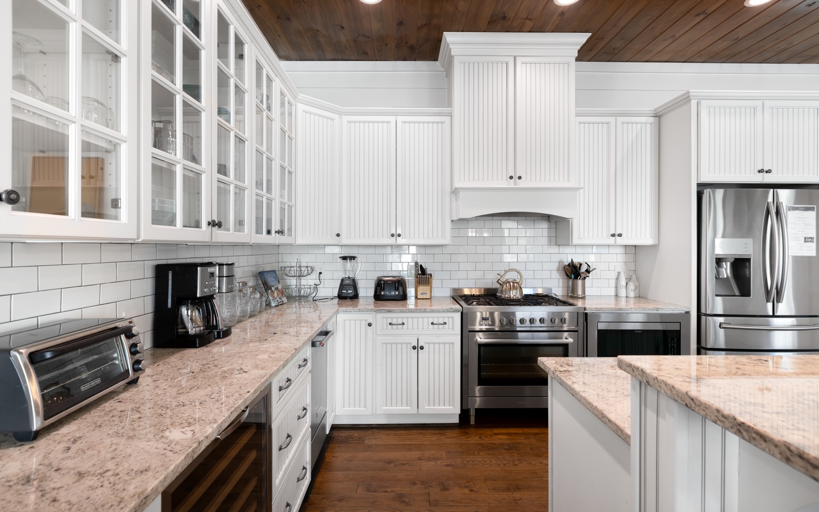 You'll love preparing meals in this stunning white kitchen with granite countertops, stainless appliances, and abundant cabinet space for all your needs.