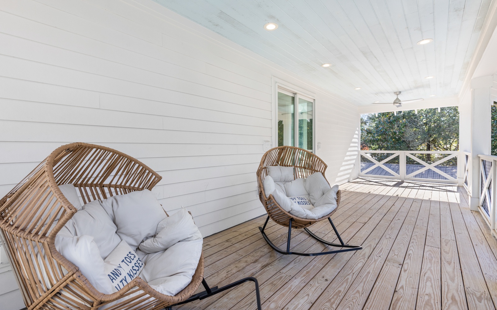 Sink into plush wicker chairs on your private covered deck, where afternoon breezes and leafy views create the perfect spot for morning coffee.
