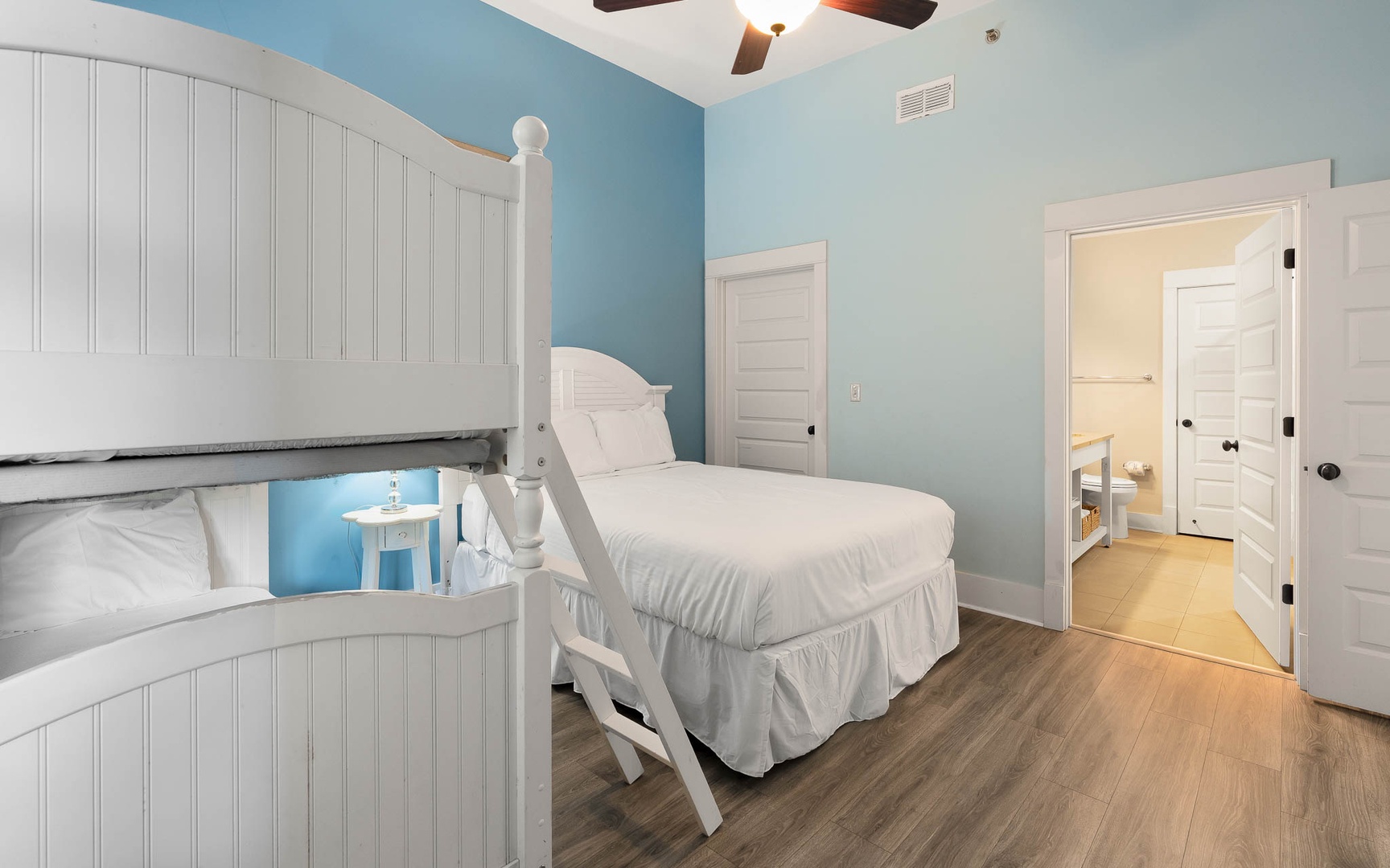 Rest peacefully in your coastal bedroom with crisp white linens and cheerful blue walls that create a calming seaside retreat.