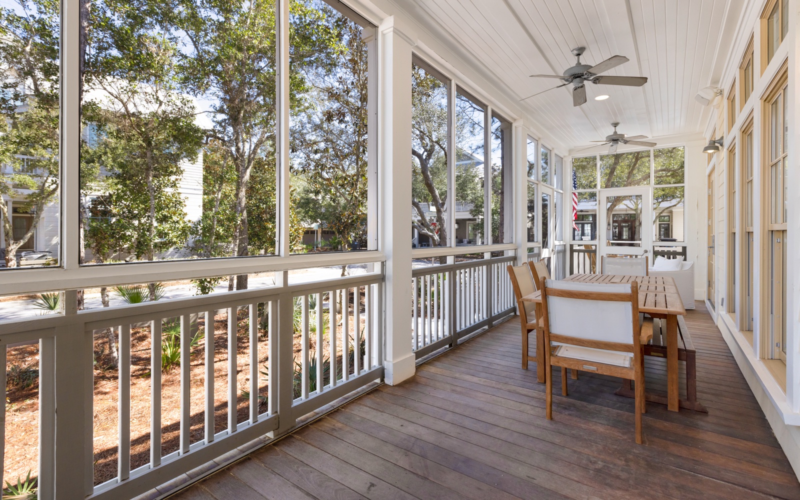 Relax on your screened porch with comfortable seating, ceiling fans, and peaceful tree-lined views for morning coffee or evening unwinding.