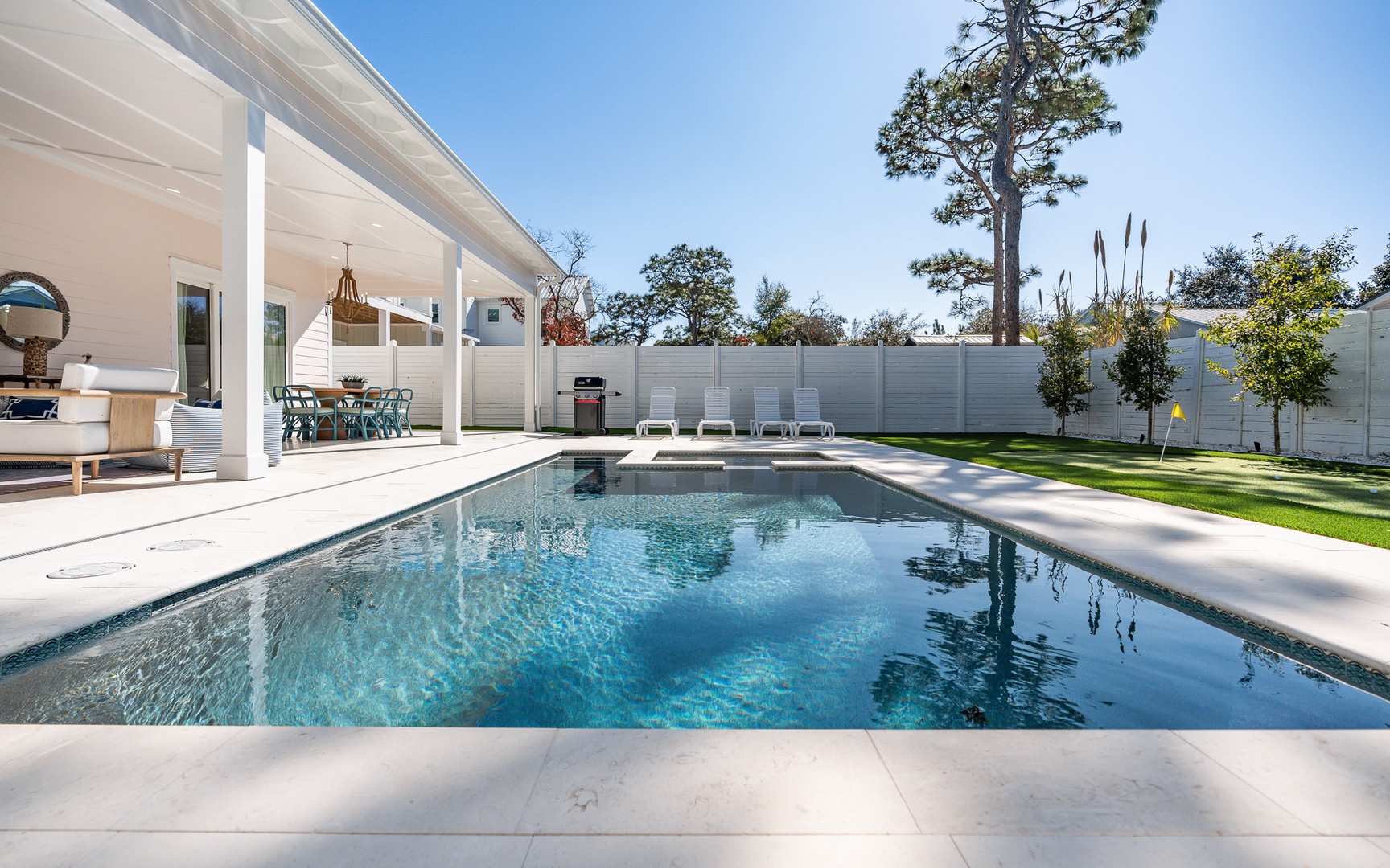Dive into your private oasis where crystal-clear waters reflect sunny skies, while your covered patio offers the perfect poolside retreat.