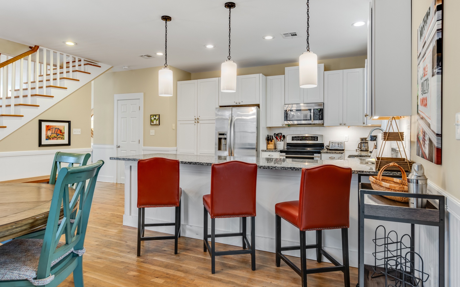 Gather around the spacious kitchen island where meals become memories, featuring gleaming granite counters and stylish pendant lighting for your culinary adventures.