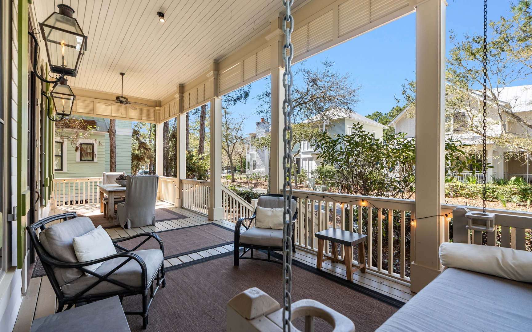 Relax on your covered porch with comfortable seating, gentle swings, and peaceful neighborhood views through mature trees.