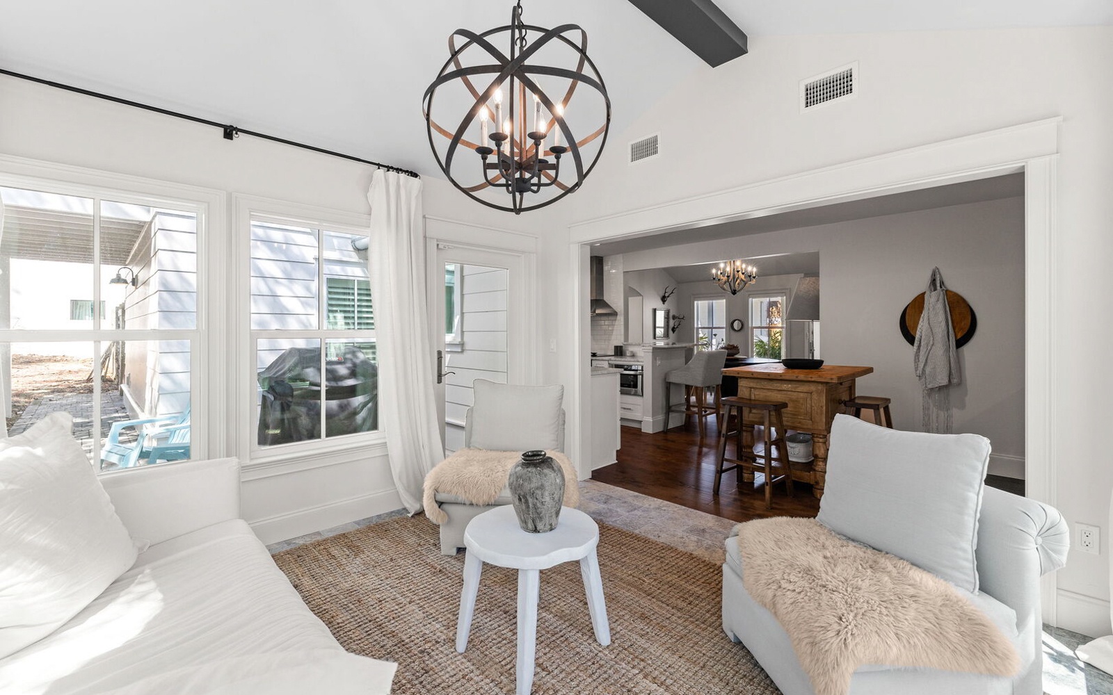 Settle into your bright, open-plan living space where comfort meets style beneath stunning beamed ceilings and elegant lighting.