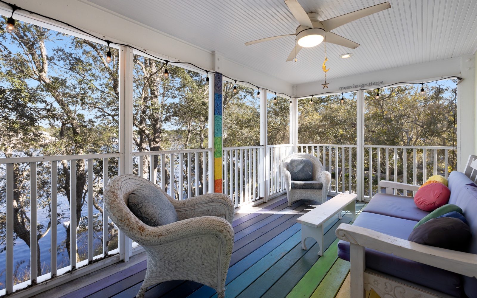 Relax in your private screened porch with colorful seating and peaceful treetop views—perfect for morning coffee or evening conversations.