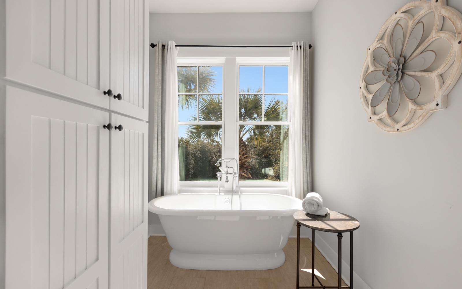 Soak in your elegant freestanding tub while gazing at swaying palms through the window—pure tropical tranquility awaits.