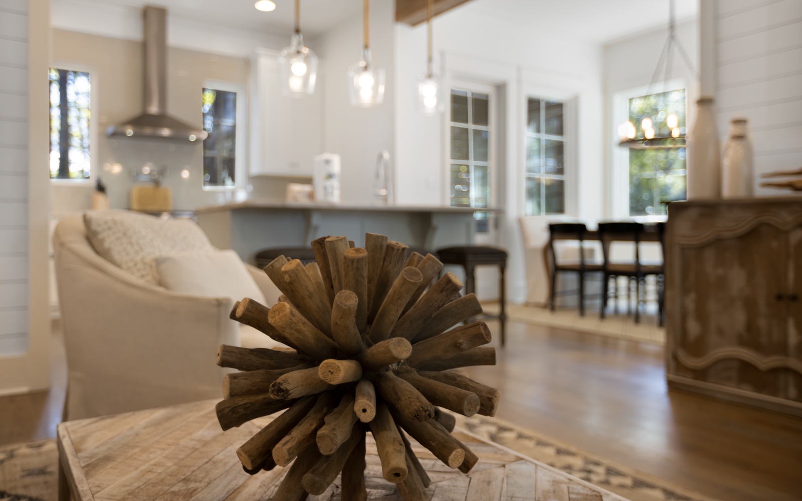 Your bright, open-concept living space seamlessly blends comfort and style with sleek pendant lighting, cozy seating, and a modern kitchen perfect for memorable stays.