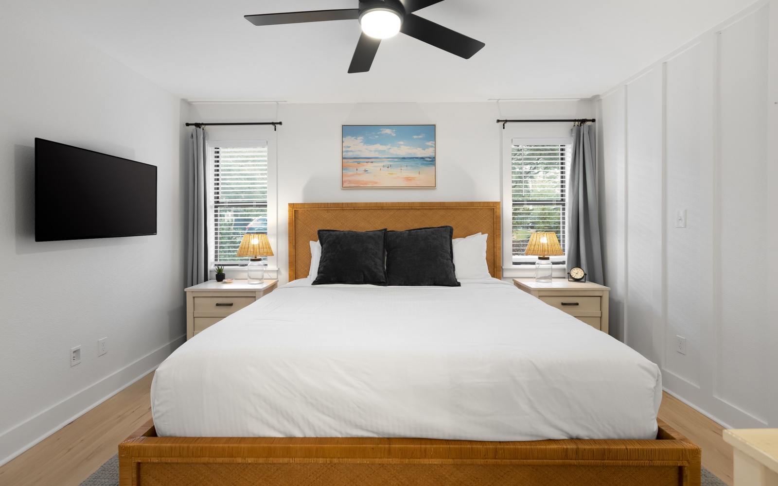 Drift off in your bright, airy bedroom with crisp linens and ocean artwork creating coastal vibes above your comfortable bed.