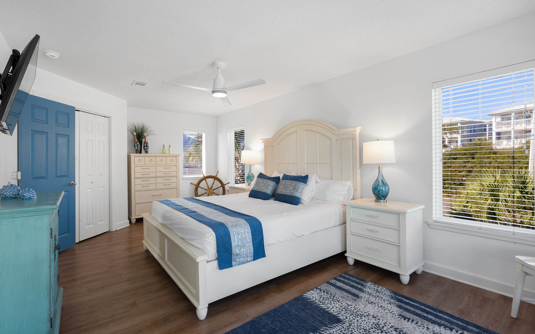 Sink into coastal comfort in your serene bedroom, where ocean-inspired blues meet crisp white linens for your perfect getaway retreat.