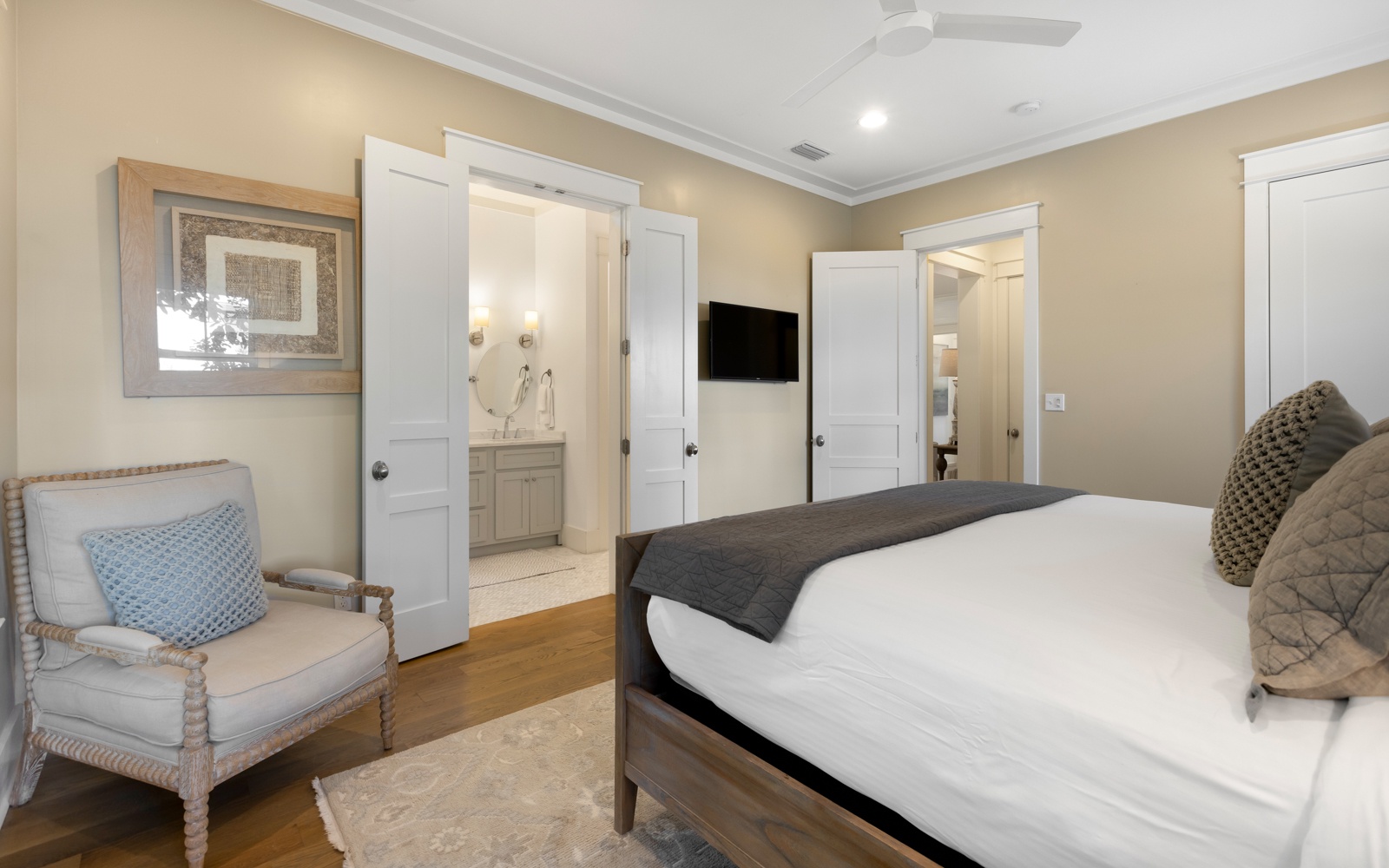 Settle into your elegant bedroom featuring warm wood floors, cozy seating, and your own en-suite bathroom for ultimate comfort.