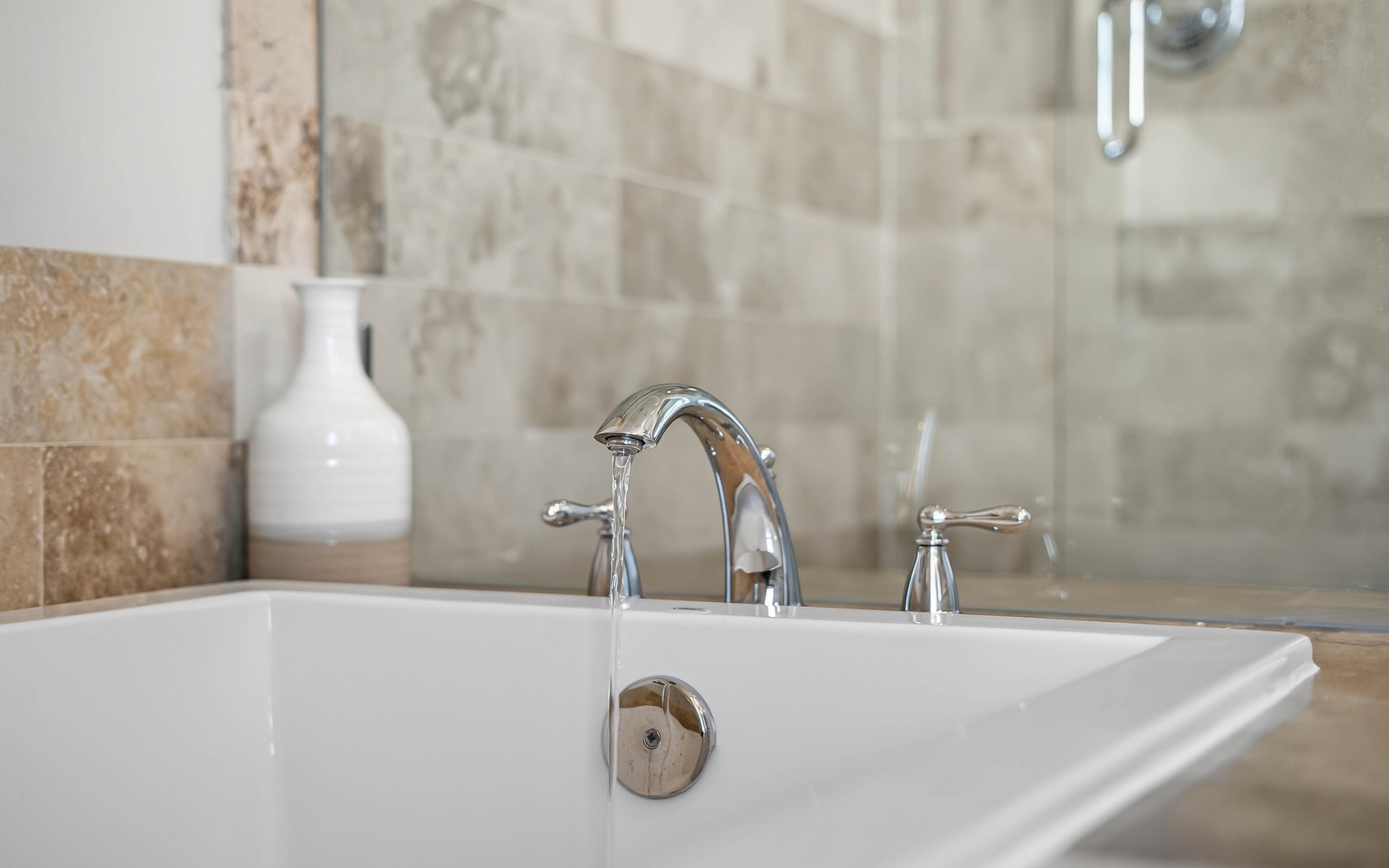 Slip into your elegant marble-tiled bathroom and unwind in the deep soaking tub with polished chrome fixtures.