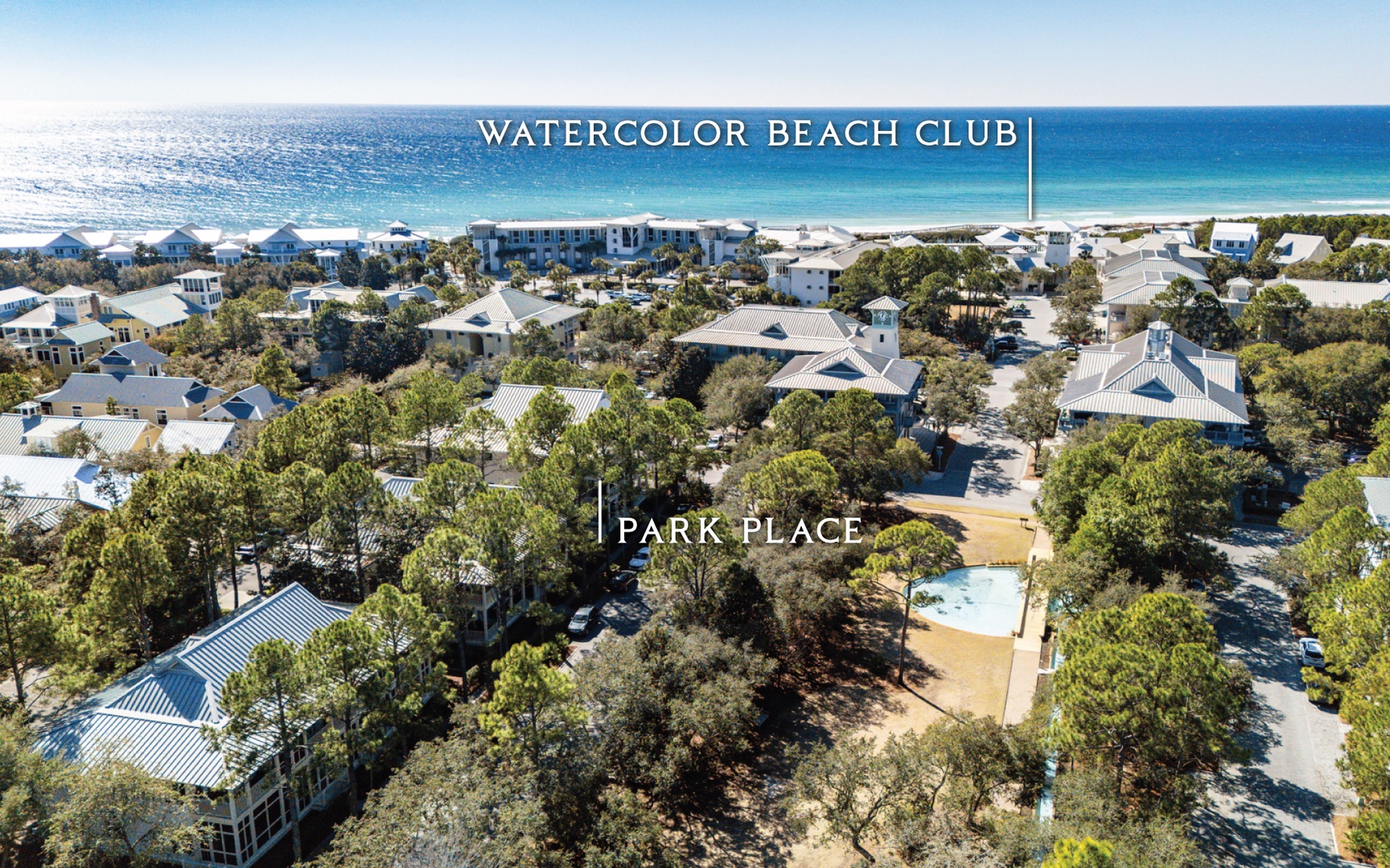 Aerial view of community with pristine white sand beaches and turquoise waters nearby.