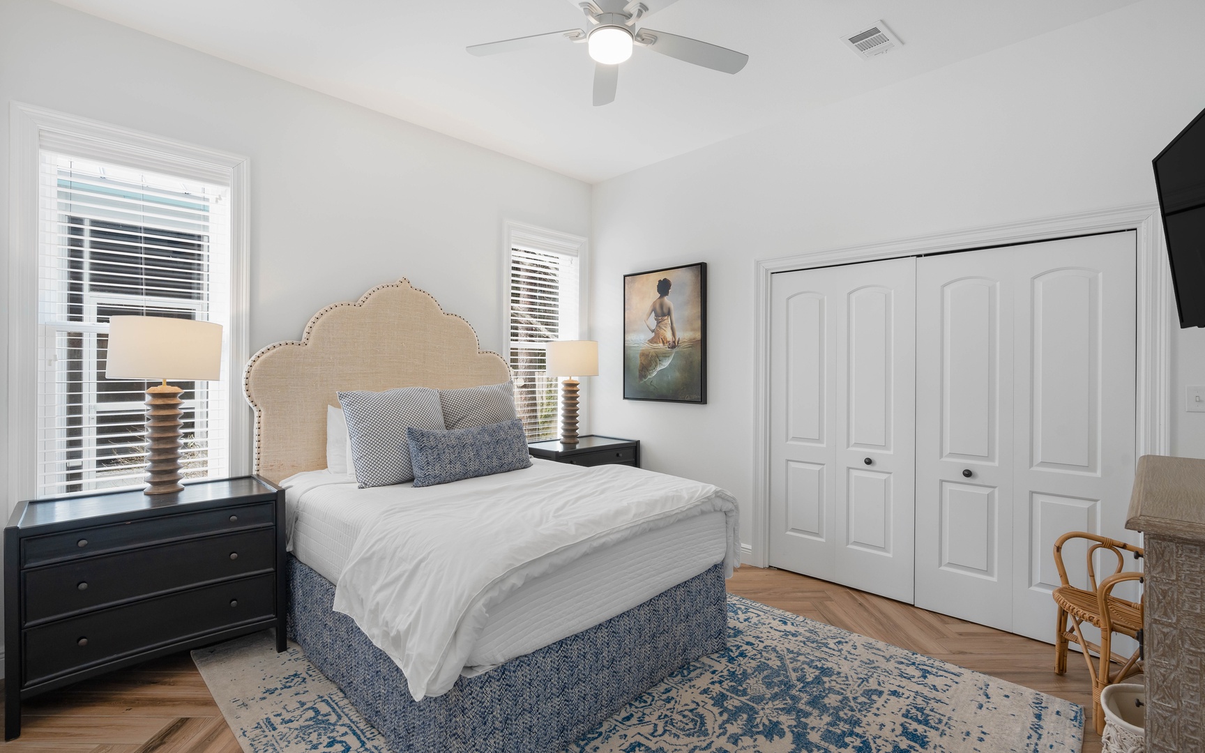 Drift off peacefully in your elegantly appointed bedroom, where coastal charm meets comfort with crisp linens and gentle ceiling fan breezes.
