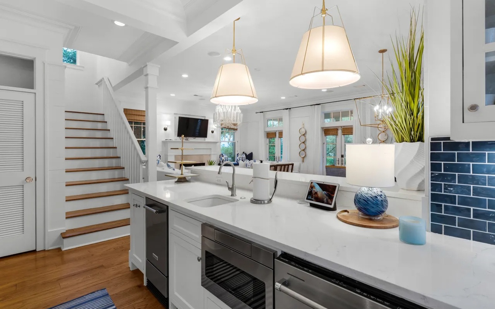 Your gourmet kitchen flows seamlessly into the living space, where natural light dances across marble counters and warm wood floors.