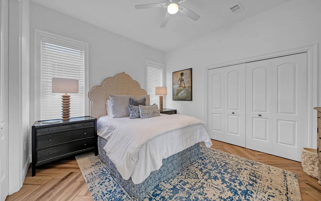 Drift into peaceful dreams in this serene bedroom, where crisp white linens and elegant furnishings create your perfect retreat.