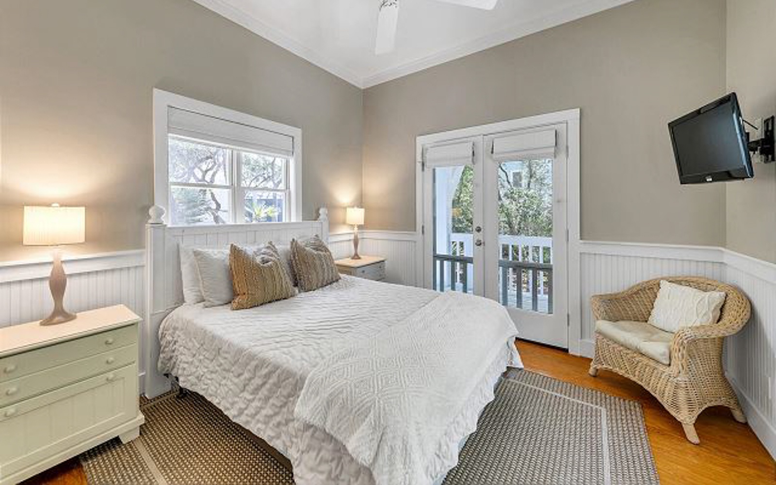 Sink into crisp white linens in your serene bedroom, complete with a cozy reading chair and private balcony access for morning coffee moments.