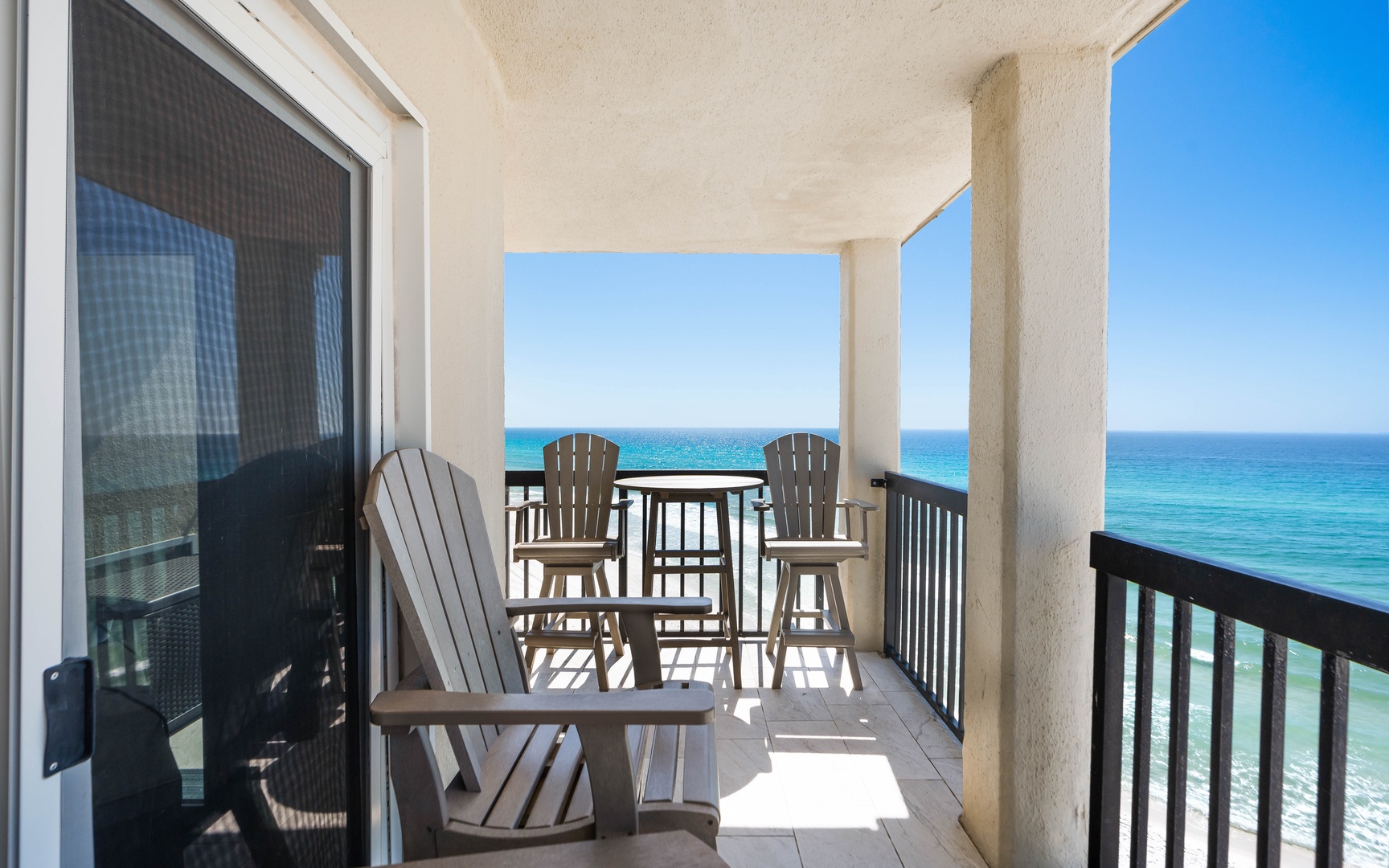 Your private balcony overlooks endless turquoise waters, where Adirondack chairs invite you to sip morning coffee while ocean waves create the perfect soundtrack.