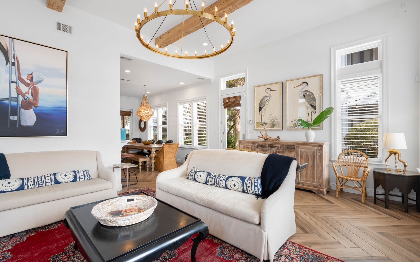 Sink into plush seating surrounded by coastal-inspired artwork and warm wood accents, where natural light streams through plantation shutters.