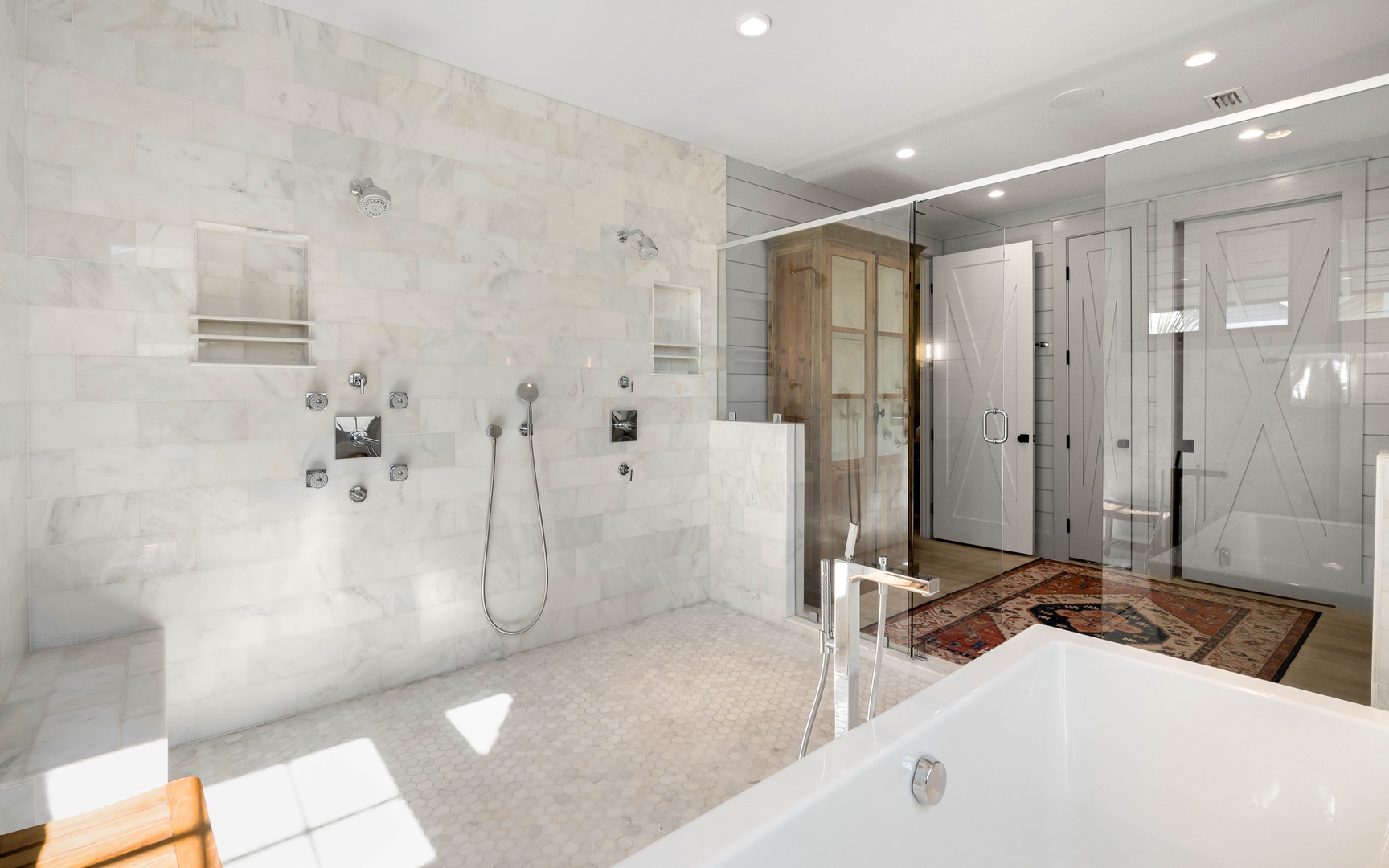 Indulge in your luxurious spa-like bathroom featuring dual rain showers, marble finishes, and a soaking tub for pure relaxation.