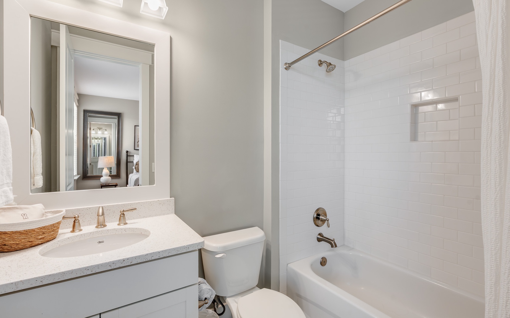 Refresh in your bright, modern bathroom featuring a deep soaking tub, rainfall shower, and pristine white subway tile surrounds.