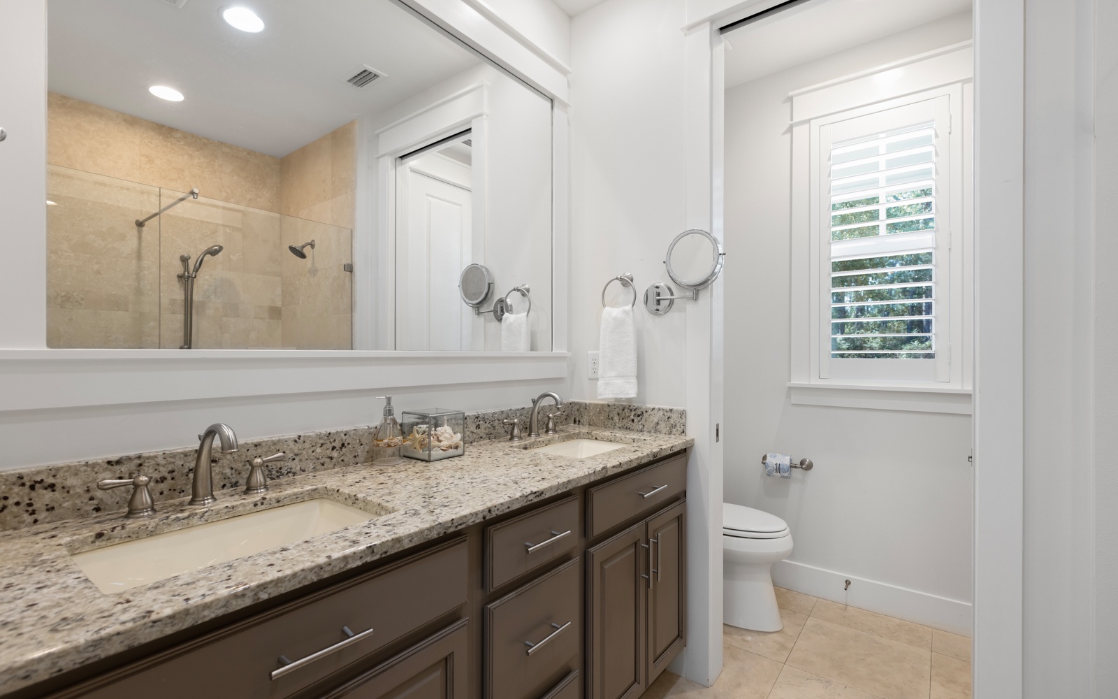 Enjoy this elegant bathroom with granite counters, dual sinks, and walk-in shower - your private spa-like retreat.