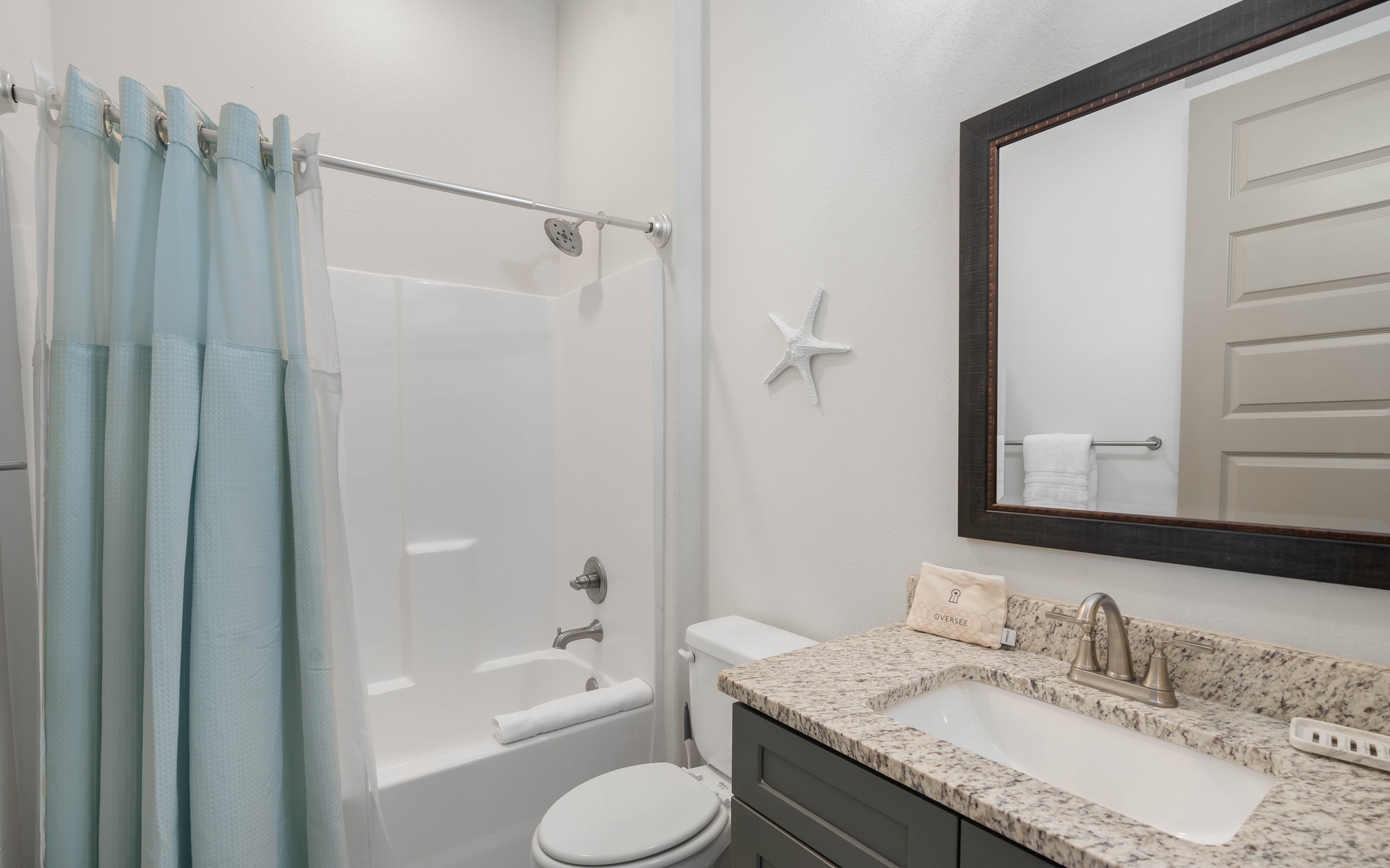 Refresh in your private bathroom with a soothing shower-tub combo and granite vanity—coastal touches add charm.