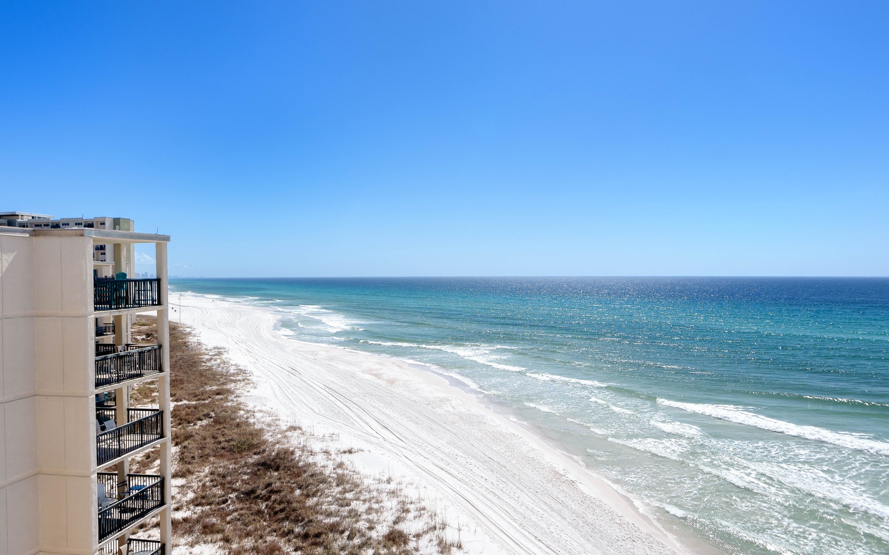 Stunning beachfront location with pristine white sand beaches and crystal-clear turquoise waters stretching to the horizon.