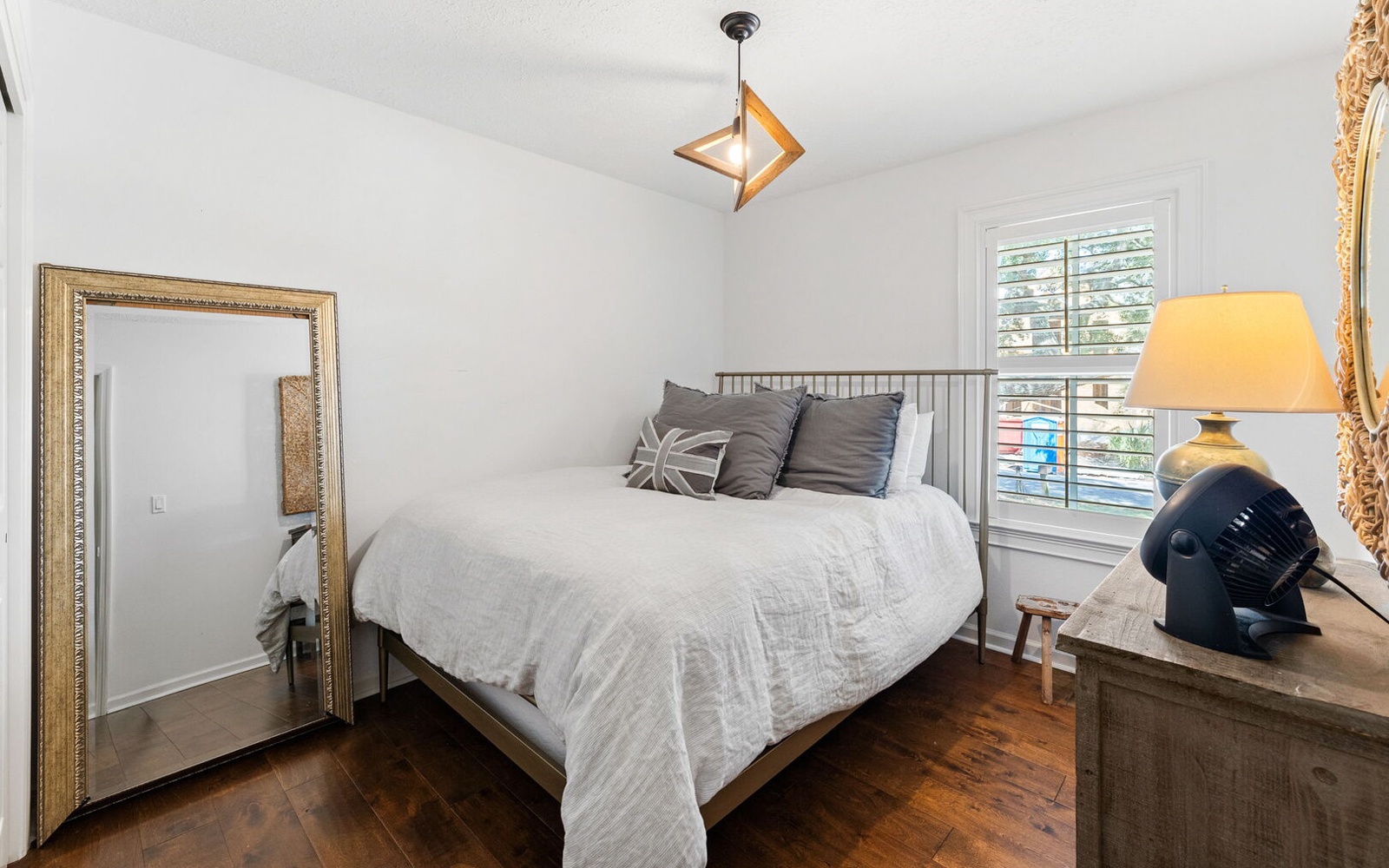 Drift off in your serene bedroom sanctuary with crisp white linens, warm hardwood floors, and soft ambient lighting.