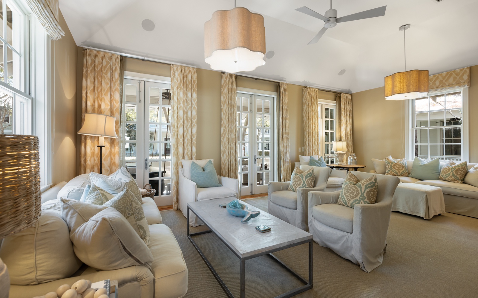 Sink into plush sofas and armchairs in your elegant living room, where soft lighting and French doors create a serene retreat.