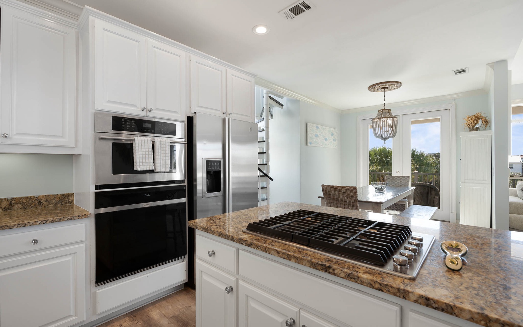 Your gourmet kitchen awaits with granite counters, stainless appliances, and gas cooktop - perfect for creating memorable meals together.