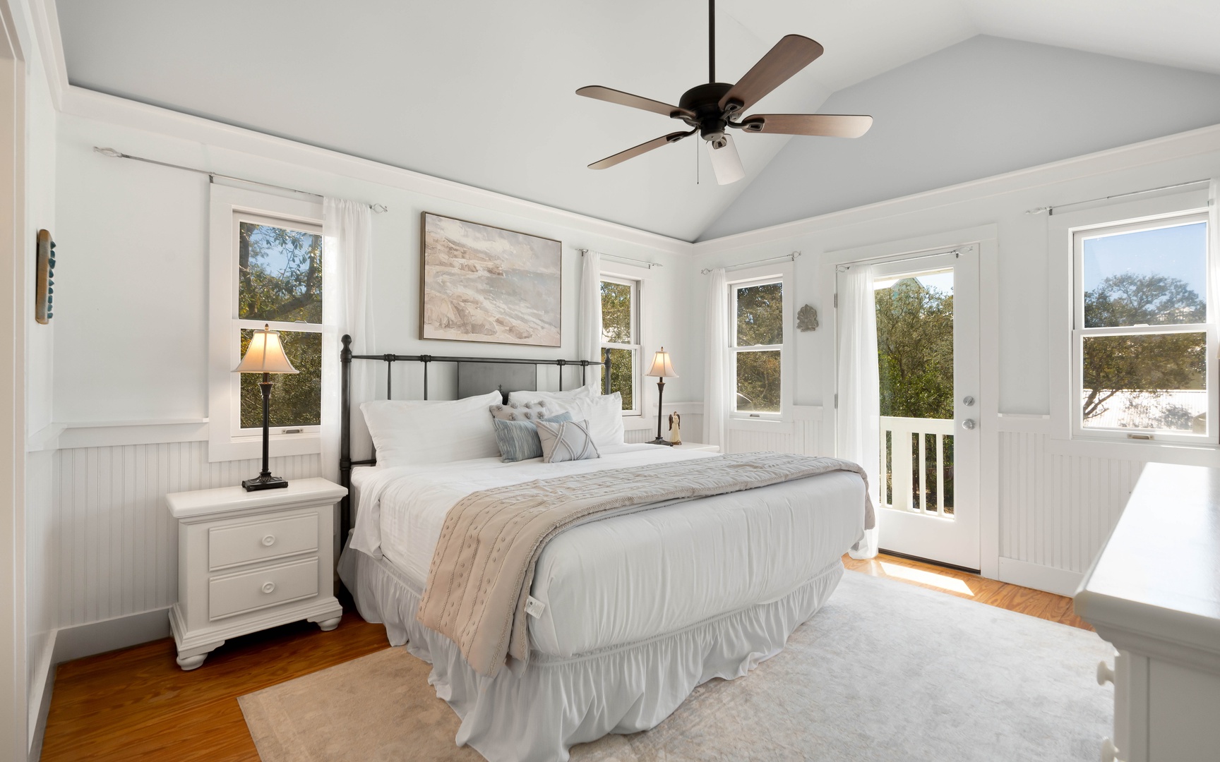 Drift into peaceful slumber in your airy bedroom with vaulted ceilings, gentle fan breeze, and French doors opening to your private balcony.