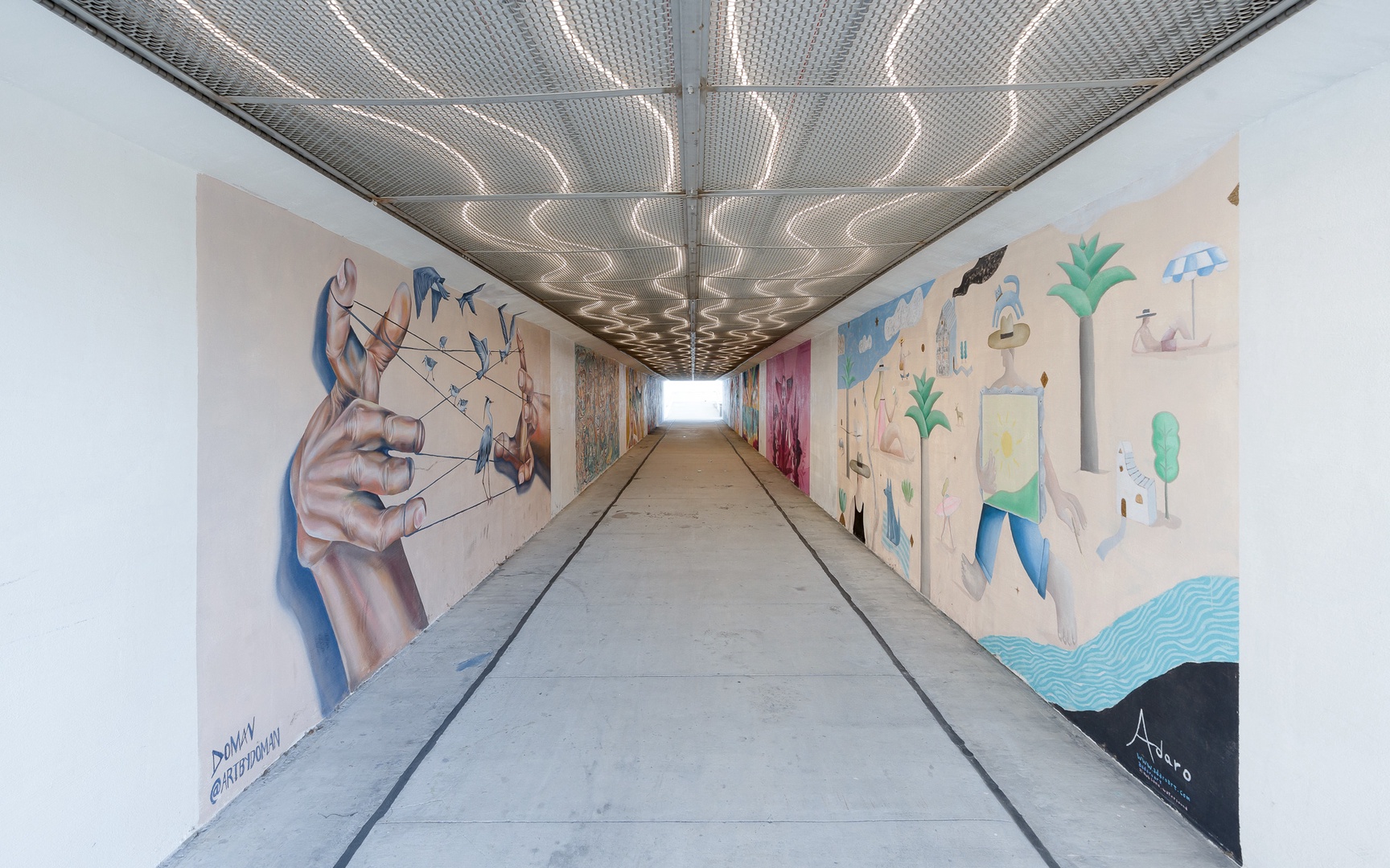Underground passage adorned with vibrant street art connects different areas of the neighborhood.