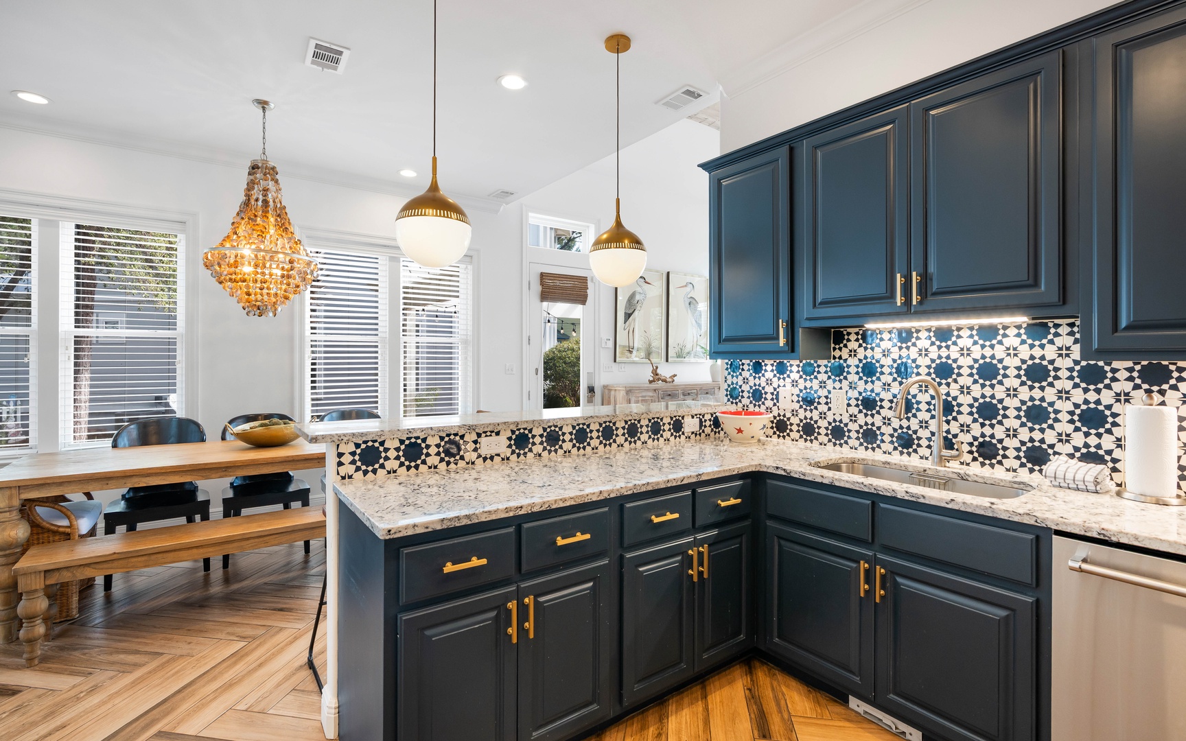 Your gourmet kitchen features navy cabinets, gold hardware, and stunning mosaic tiles—perfect for creating memorable meals together.